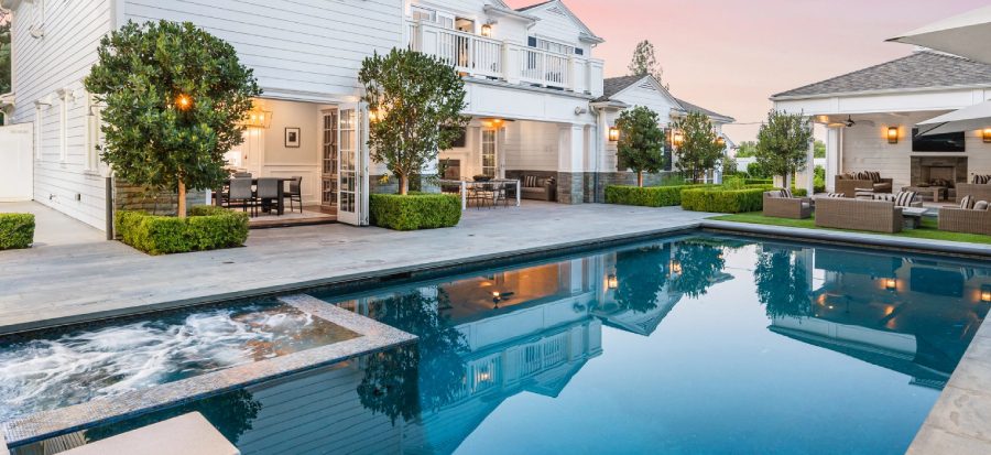 Modern house with pool and patio area.